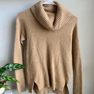 Tan Turtleneck, long sleeved and hits normally just below or around waist level!